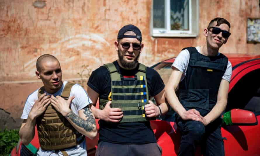 In the district of Kharkiv, three young Ukrainians, Alexii (L) Nazar Tishchenko (C) and Oleg Vadimovich (R), deliver humanitarian aid every day in a car stuffed with food, techno music blaring in the speakers.