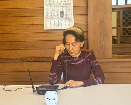 Aung San Suu Kyi talks on the phone with her son on Thursday, in a photo released by the Myanmar presidential office. Photograph: Myanmar President Spokesperson Office/AP