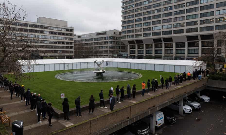 A queue outside a Covid-19 vaccination centre at St Thomas' hospital in London, 13 December 2021.