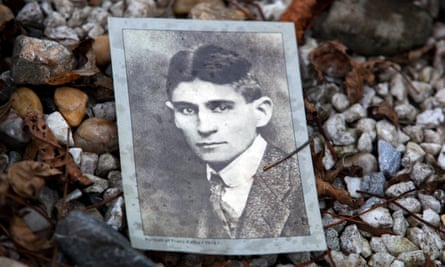 Photo of Franz Kafka on his grave at the New Jewish Cemetery.