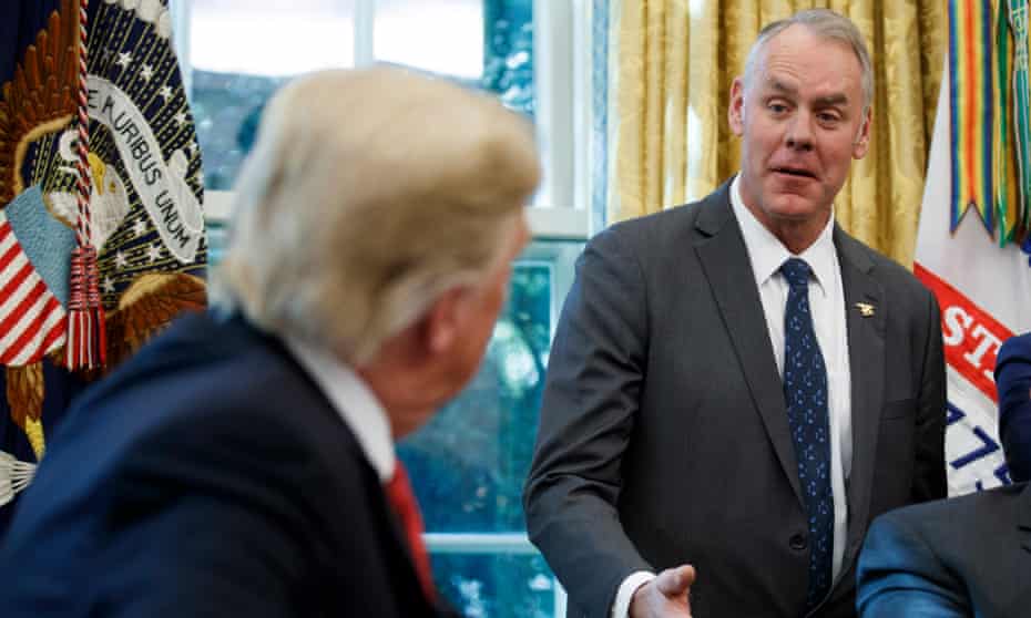 Donald Trump listens as secretary of the interior Ryan Zinke delivers remarks in October.