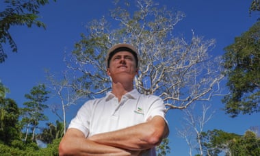 Nelson Kroll, manager of Madaracre forestry concession in Madre de Dios, stands in front of a Shihuahuaco tree