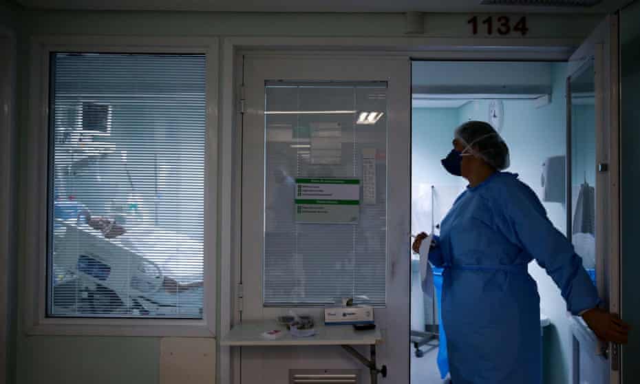 A medical staff member near a patient at the intensive care unit of the Nossa Senhora da Conceicao hospital, during the coronavirus outbreak in Porto Alegre, Brazil