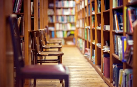 Library with books on shelf and empty chairs