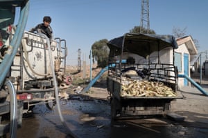 Trucks transport water from wells in the countryside east of Hasakah to the city