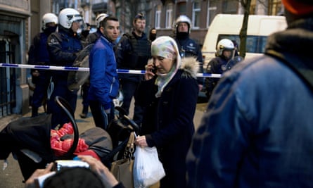 Locals stuck outside a security perimeter around Rue de la Carpe in Molenbeek-Saint-Jean in Brussels last week.