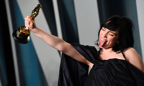 The singer-songwriter Billie Eilish holds the award for Best Music (Original Song) for “No Time to Die” as she attends