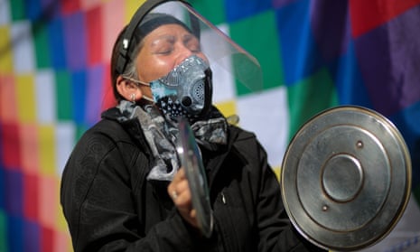 A demonstrator makes noise with pan lids at a protest in La Paz, Bolivia. 