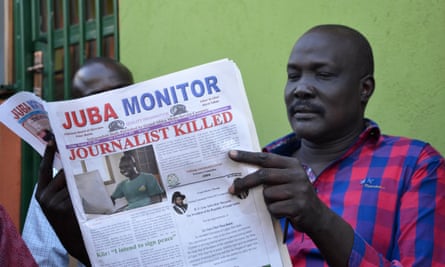 A man reads a copy of the Juba Monitor
