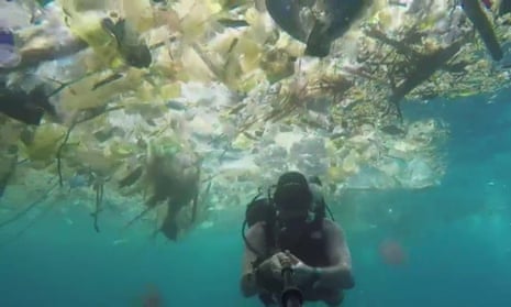 Rich Horner swims through masses of plastic waste off Bali