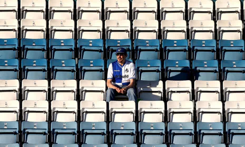 A lone Bristol Rovers fan sits at the Checkatrade Trophy game with Reading U23s