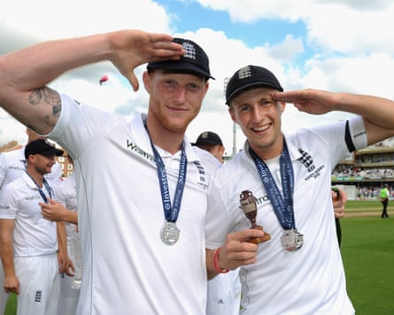 The England cricketers Ben Stokes (left) and Joe Root (right) salute and pose with the Ashes after winning the series in 2015.