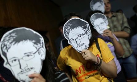 People use masks with pictures of Snowden masks during the testimonial of Glenn Greenwald before a Brazilian congressional committee on NSA’s surveillance programs, in Brasília in 2013.