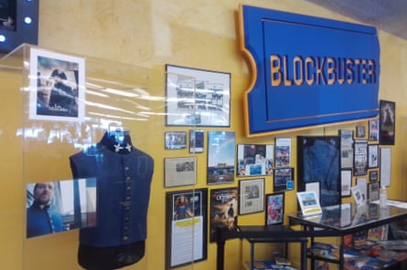 blockbuster sign over news articles and a jacket worn by Russell Crowe in Les Miserables