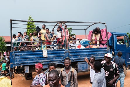 Refugees get ready to leave a truck.