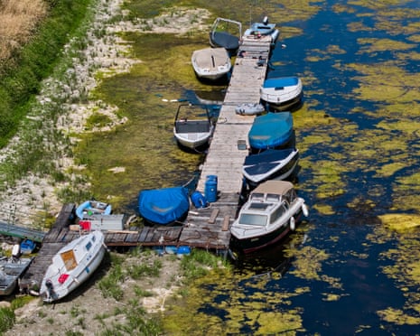 Boats are stranded in a side arm of the river Rhine that is running out of water in Mackenheim near Mainz, Germany.