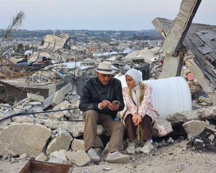 Malak Tantesh and her father, Amjed Tantesh, in the ruins of their home in Beit Lahia, northern Gaza.