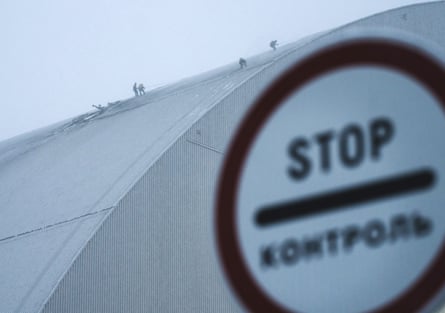 People inspecting the damage to the radiation containment shield of reactor 4 at the Chernobyl nuclear plant site in Ukraine in February