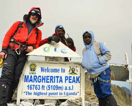 The writer (left) and guides at the summit of Margherita in Uganda’s Rwenzori mountains.