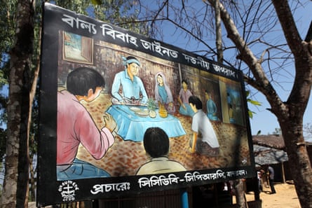 A billboard in Bandarban, Bangladesh, informs people child marriage is illegal and a serious offence.