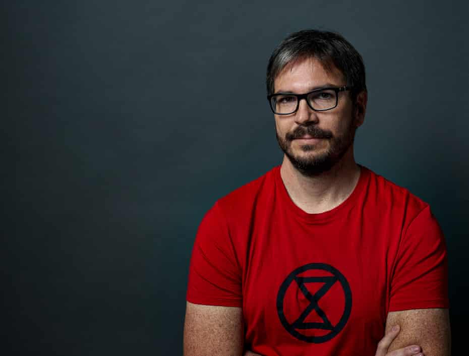 peter kalmus poses for a portrait in an extinction rebellion t-shirt