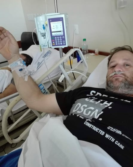 Julio de los Santos in a hospital bed wired up to diagnostic machines.