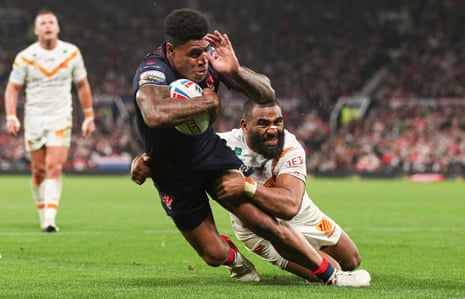 St Helens’ Kevin Naiqama holds off Samisoni Langi to score his side’s second try.