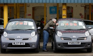 A customer looks at the cars on sale at Cargiant