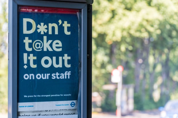 A Transport for London ‘Don’t take it out on our staff’ poster at a bus stop