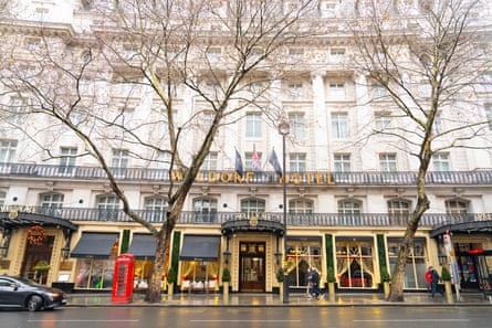 The front of an early 20th-century building on a London street with a red telephone box