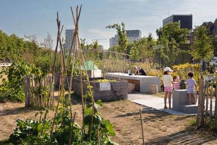 An park or garden area with several children playing and a couple sitting in the background.