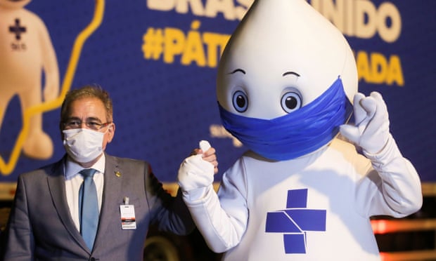 Brazil’s health minister, Marcelo Queiroga, and the country’s vaccination campaign mascot Zé Gotinha celebrate as Pfizer/BioNTech Covid jabs arrive at Viracopos airport near São Paulo.