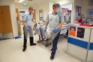 A Covid patient is moved within ward 30.