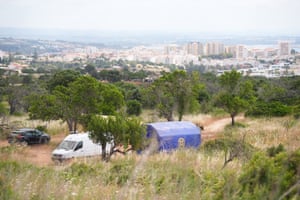 a hillside with police vans