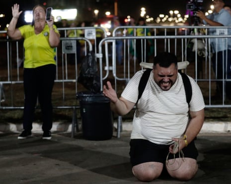 Bolsonaro supporters in Brasília pray after his defeat in the runoff election