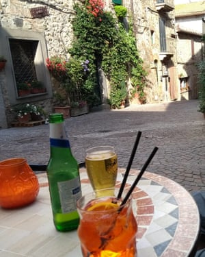 Drinks outside bar in Allerone, with village street