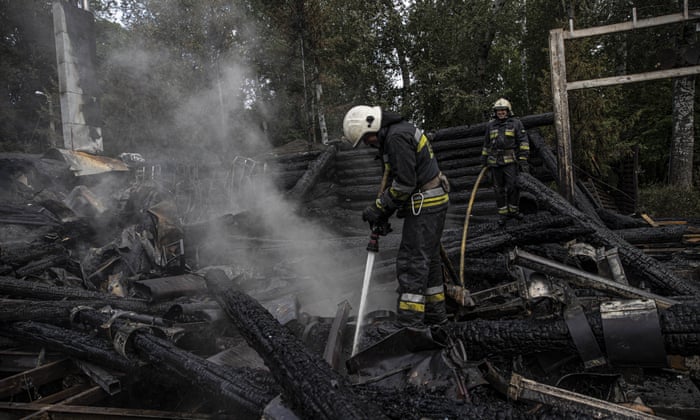 Firefighters at the remains of a destroyed restaurant in Kharkiv following Russia’s overnight airstrike on the city