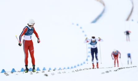 Norway’s Johannes Høsflot Klæbo looks back on his competition before crossing the finish line in the men’s cross country sprint classic final at the 2026 Winter Olympics.