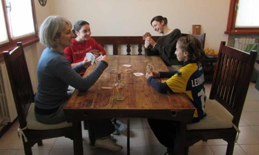 The Jones family, Francesca, Emma, Benedetta and Leonardo, play cards at home during the lockdown.