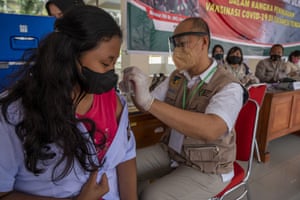 A medical worker injects Covid-19 vaccine into a student in Palu, Central Sulawesi Province, Indonesia.