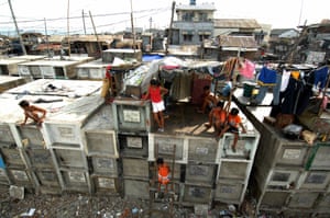  Children at their shanty homes built on top of tombs in a graveyard in the northern Manila port district of Navotas, one of the world’s most densely populated areas. 