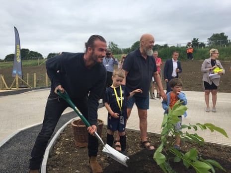 David Beckham planting a tree with Michael Eavis.
