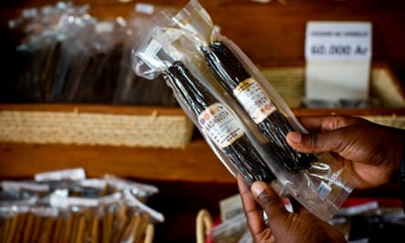 A market trader holds up pods of fresh vanilla that have been packaged ready for export at a market in Antananarivo, Madagascar.