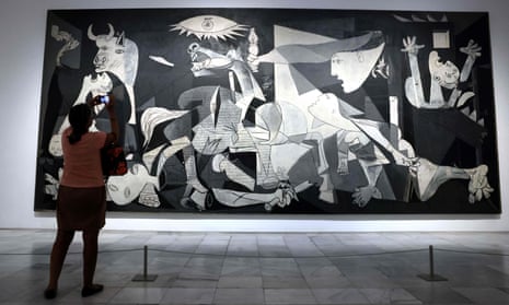 A visitor takes pictures of Spanish painter Pablo Picasso's masterpiece, Guernica, at the Reina Sofia museum in Madrid, on 12 September.