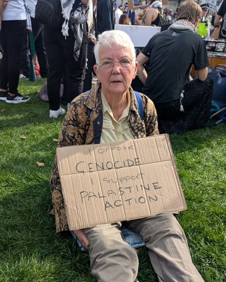 Judith Gradwell holding a sign saying âI oppose genocide. I support Palestine Actionâ.