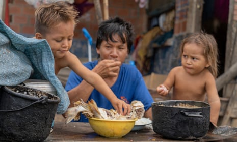 Children eat fish in a Bolivian village