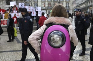 Lisbon, PortugalA woman carrying a cat in a backpack stops to watch a demonstration in support of Brazil’s former President Luiz Inacio Lula da Silva.
