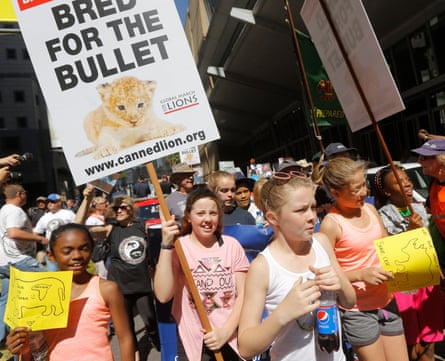 Animal rights activists carry placards outside the Sandton convention centre in Johannesburg, where the Cites summit is being held.