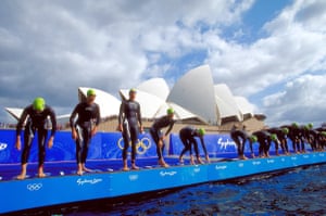 Competitors line up for the start of the women’s triathlon at the Opera House during day one of Games.