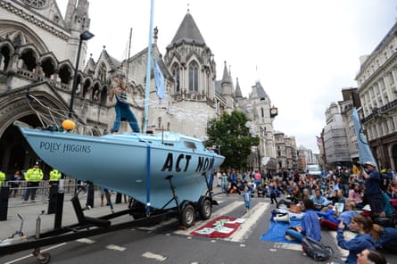 Protesters from Extinction Rebellion with a boat that has been parked outside the Royal Courts of Justice in London.